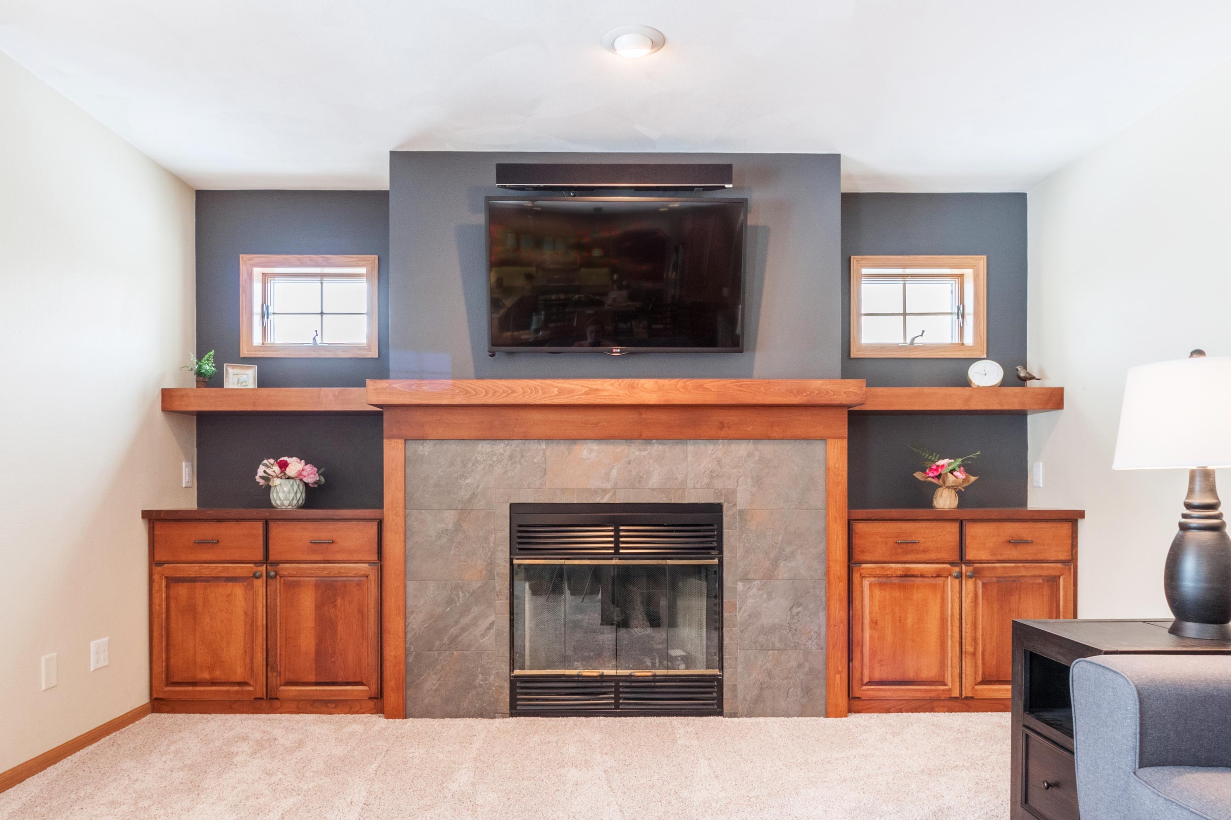 Professional TV Mounting Birmingham AL - Expert technician installing a TV above fireplace